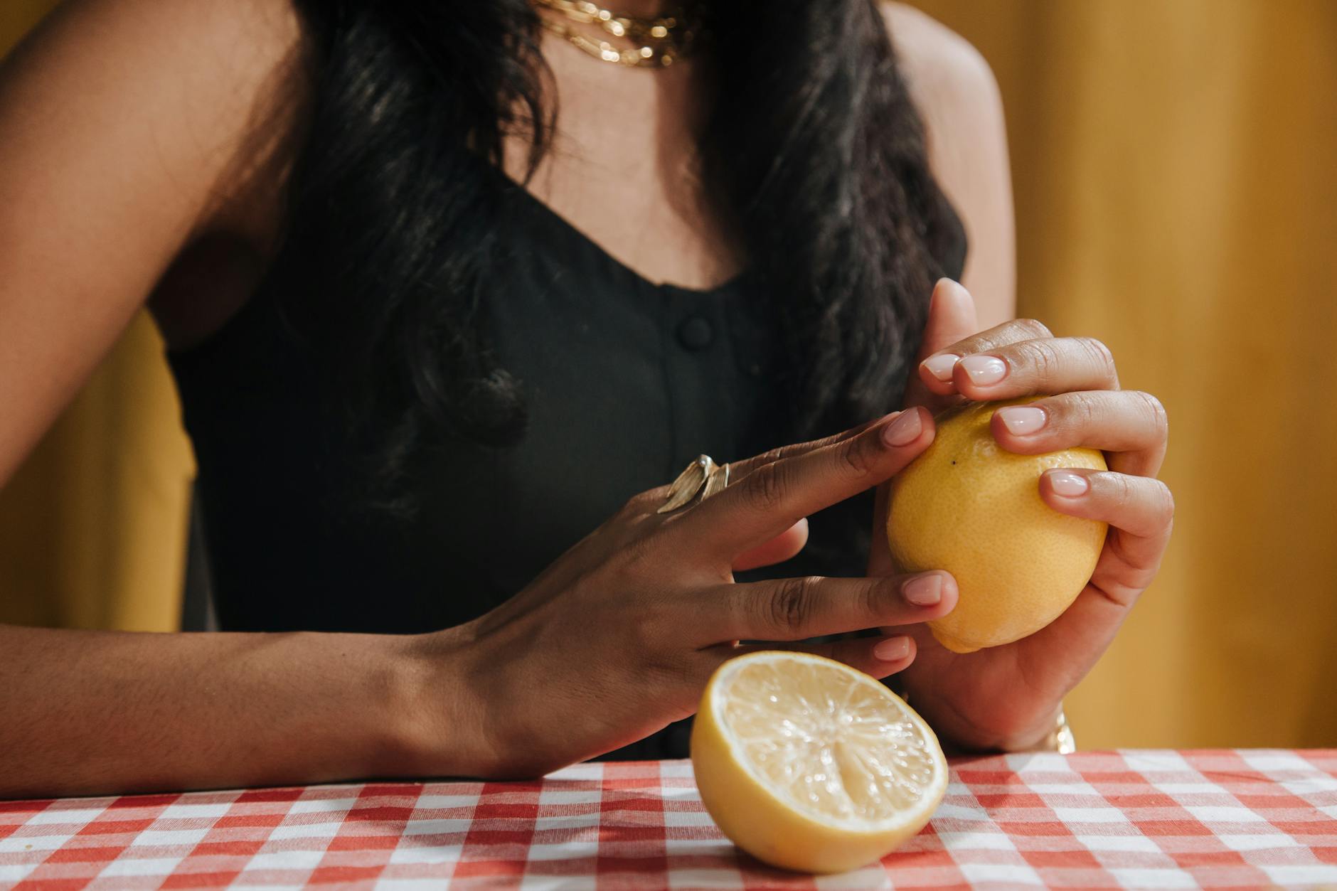 Woman holding a blue silicone vibrator in a focused, contemplative expression
