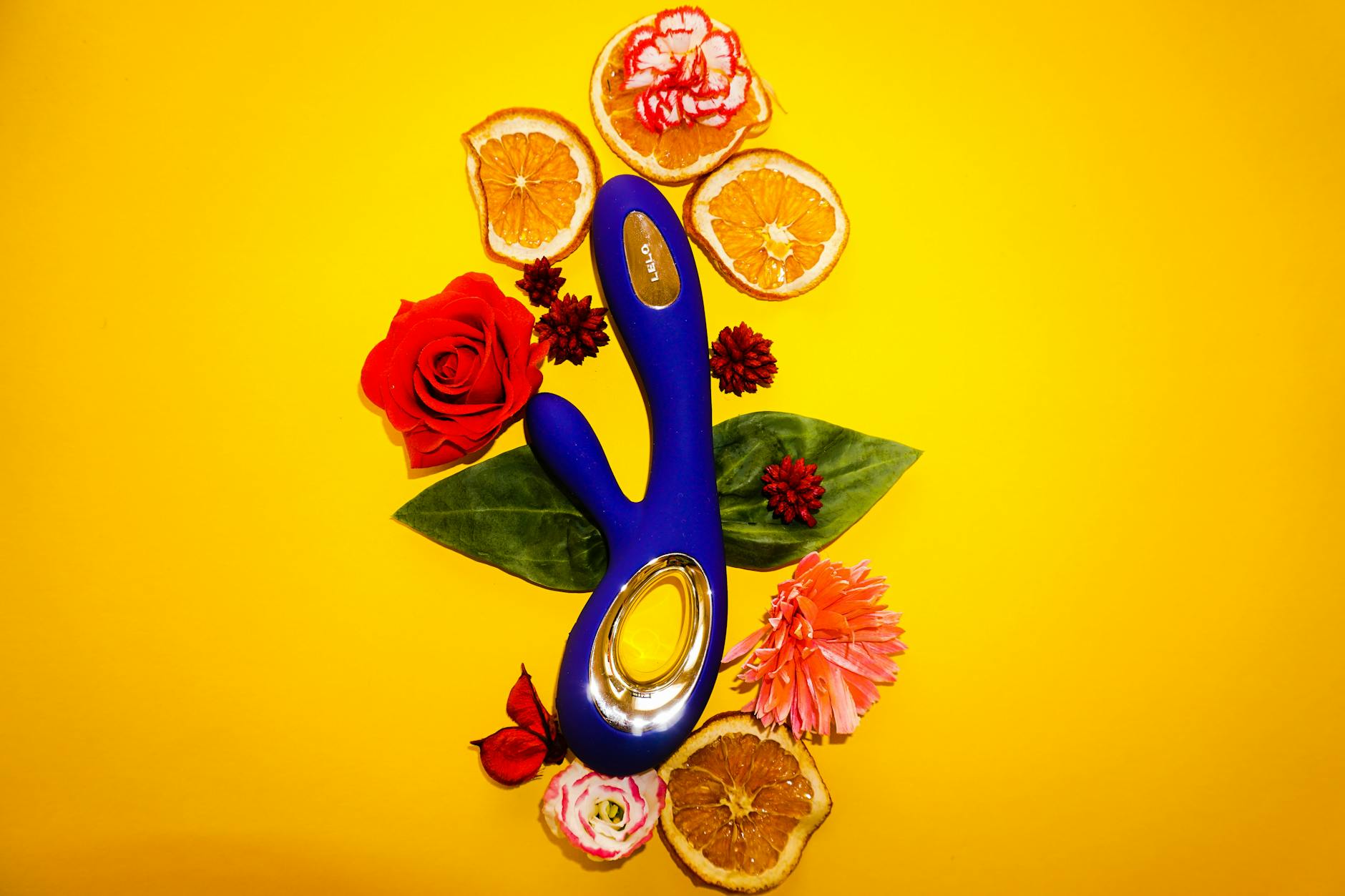 A woman holding two colorful vibrators, representing options for partnered intimacy